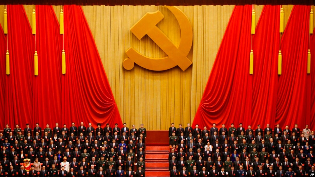 FILE - Chinese President Xi Jinping, front row center, stands with his cadres during the Communist song at the closing ceremony for the 19th Party Congress at the Great Hall of the People in Beijing on Oct. 24, 2017.