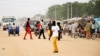 South Sudanese residents walk along a street of Bor, in Jonglei state. Around 1 million children in South Sudan have been forced to flee their homes since conflict erupted a year ago, Dec. 10, 2014.