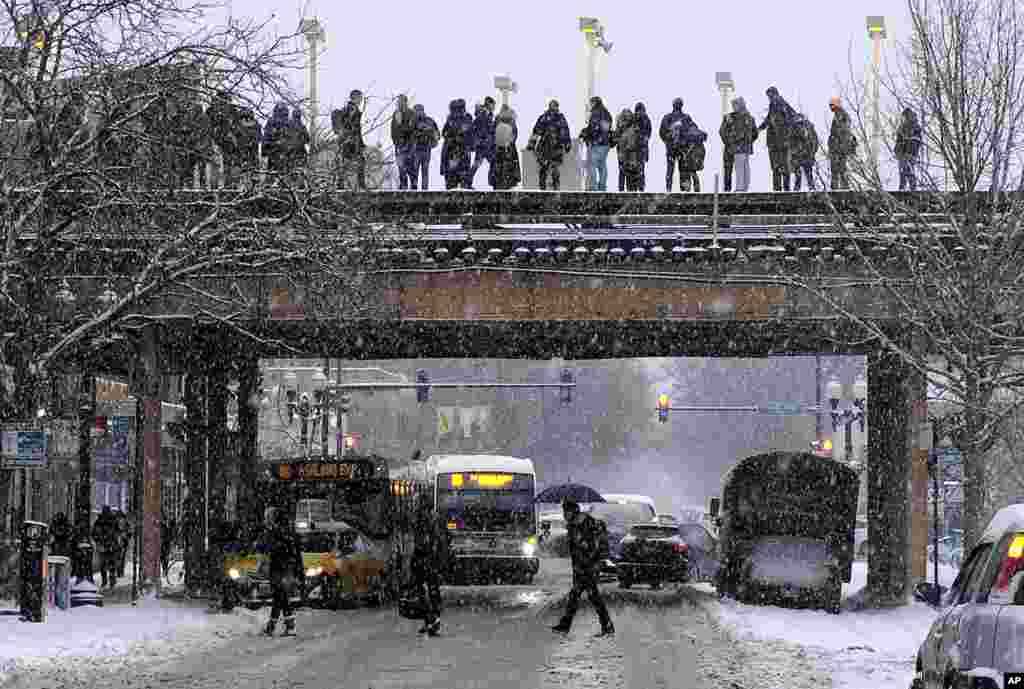 Commuters wait for a train as snow falls in Chicago, Illinois, Jan. 28, 2019. The plunging temperatures expected later this week have forecasters especially concerned. Wind chills could plunge the temperature negative 55 degrees in northern Illinois, which the National Weather Service calls "possibly life threatening."