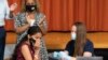 FILE - A high school student reacts after getting a COVID-19 vaccine shot in New York City, July 27, 2021. 
