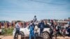 Musician-turned-politician Bobi Wine (on top of car) greets supporters as he makes his way to be officially nominated as a presidential candidate, in Kampala, Uganda, Nov. 03, 2020.
