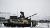 A Russian service member stands on a BMP-3 infantry fighting vehicle during drills held by the armed forces of the Southern Military District at the Kadamovsky range in the Rostov region, Russia Jan. 27, 2022.