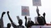 South Sudanese hold banners during a rally in support of President Salva Kiir's administration in Juba, March 10, 2014. 