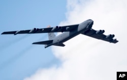 FILE - A U.S. Air Force B-52 strategic bomber flies over Pabrade during a military exercise north of Vilnius, Lithuania, June 16, 2016.
