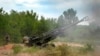 FILE - Ukrainian soldiers fire at Russian positions from a U.S.-supplied M777 howitzer in Ukraine's eastern Donetsk region, June 18, 2022. 