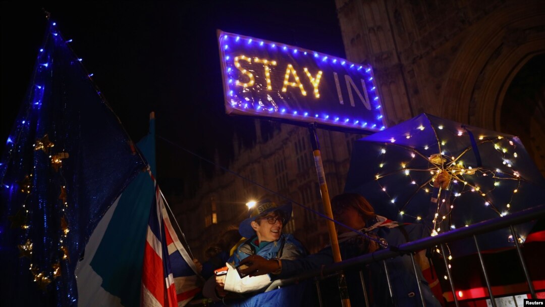 Anti-Brexit demonstrators stand outside the Houses of Parliament in London, Sept. 9, 2019.