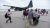 U.S. Air force personnel evacuate residents from Princes Juliana International Airport after the passage of Hurricane Irma, in St. Martin, Sept. 12, 2017. Irma cut a path of devastation across the northern Caribbean, leaving thousands homeless after destroying buildings and uprooting trees. 
