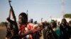 Rebel fighters hold their weapons as they march in a village in the rebel-controlled territory of Upper Nile state, South Sudan, Feb. 9, 2014.