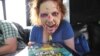 Comic Con attendee Amanda Sankey from Los Angeles plays Zombie Burbz in WowWee's AppGear truck across the street from the San Diego Convention Center, July 12, 2012 in San Diego, CA.