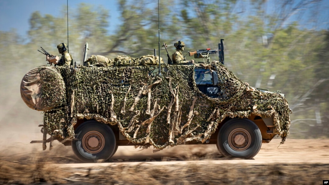 FILE - In this photo provided by the Australian Defense Force, an Australian Army Bushmaster armored vehicle moves off road during a training mission July 7, 2021, in Townsville, Australia. 