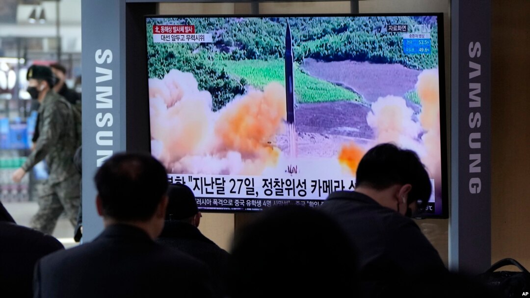  FILE - People watch a TV showing a file image of North Korea's missile launch during a news program at the Seoul Railway Station in Seoul, South Korea, March 5, 2022. 