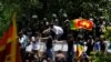 Demonstrators stand on the wall of Sri Lanka's Prime Minister Ranil Wickremesinghe's office premises, amid the country's economic crisis, during a protest in Colombo, Sri Lanka July 13, 2022. (REUTERS/Adnan Abidi)