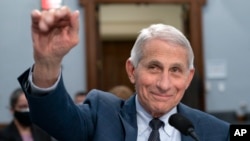 FILE - Dr. Anthony Fauci, Director of the National Institute of Allergy and Infectious Diseases, waves to a House committee at the start of a hearing on Capitol Hill in Washington on May 11, 2022.