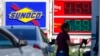 A woman pumps gas at a Sunoco mini-mart in Independence, Ohio, July 12, 2022.