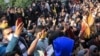 In this Saturday, Dec. 30, 2017 file photo taken by an individual not employed by the Associated Press and obtained by the AP outside Iran, university students attend a protest inside Tehran University while anti-riot Iranian police prevent them to join o