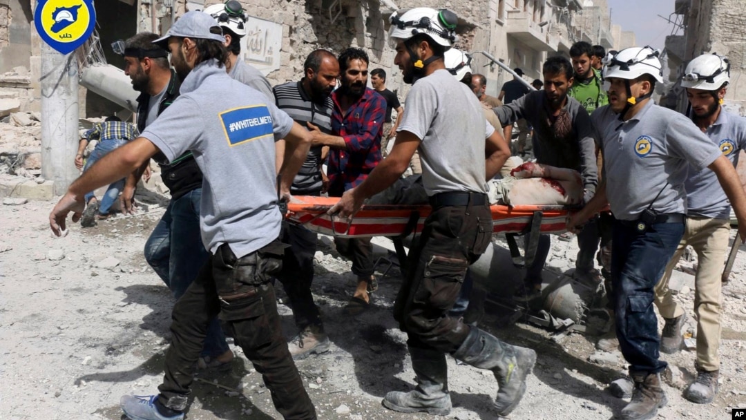 Syria Civil Defense "White Helmets" rescue people from site of airstrikes, al-Sakhour neighborhood of eastern Aleppo, Syria, Sept. 21, 2016.