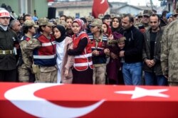 People react by the coffin for Emin Yildirim, one of the 33 Turkish soldiers killed on Thursday in a Syrian army attack in the Idlib region of Syria, at his funeral in Hatay, Turkey, Feb. 29, 2020.