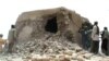 FILE - This file photo taken on July 1, 2012 shows a still from a video of Islamist militants destroying an ancient shrine in Timbuktu. The trial of a Malian jihadist charged with war crimes for ordering the 2012 destruction of 14 mausoleums of Muslim sai