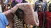 An internally displaced boy carries his belongings inside a United Nations Missions in a compound in Juba, South Sudan, Dec. 19, 2013.