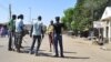 Vigilante barricade the road following an explosion at a market in Maiduguri, Nigeria, Dec. 1, 2014, with twin blasts exploding at a crowded market in Maiduguri and explosions and gunshots erupting in Damaturu. 