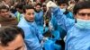 Paramedics transport an injured police officer at a hospital following a roadside bomb blast in Bajaur district, around 14 kms from the border with Afghanistan, on Jan. 8, 2024.