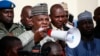 FILE - Borno state governor, Kashim Shettima, center, addresses demonstrators who were calling on the government to rescue the kidnapped schoolgirls of the Chibok secondary school, in Abuja, Nigeria, May 13, 2014. 