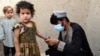 FILE - A health worker marks a child's finger with ink after giving polio vaccine at a campaign in Kandahar, Afghanistan, on June 28, 2022. 