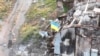 Ukrainian service members install a national flag on Snake (Zmiinyi) Island, as Russia's attack on Ukraine continues, in Odesa region, Ukraine, in this handout picture released July 7, 2022. (Press service of the Ukrainian Armed Forces/Handout via Reuters