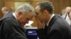 Oscar Pistorius talks with attorney Barry Roux, left, on the second day of trial, Pretoria, March 4, 2014.