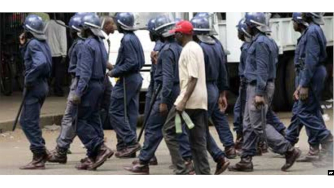 Zimbabwean police arrest an MDC supporter in Harare recently … Activists say ongoing political unrest in Zimbabwe makes it dangerous for migrants in South Africa to return to their homeland