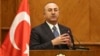 Turkish Foreign Minister Mevlut Cavusoglu, and Jordanian Foreign Minister Ayman Safadi (not shown), give a press conference in Amman, Jordan, Feb. 19, 2018. Cavusoglu said his country is ready to battle Syrian government troops if they enter an enclave in northern Syria to protect Syrian Kurdish fighters. 