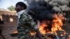 Protestors take to the streets of Burkina Faso's capital Ouagadougou Saturday Nov. 27, 2021, calling for President Roch Marc Christian Kabore to resign. 