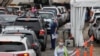Vehicles queue while medical personnel administer tests for the coronavirus disease (COVID-19) at the Bondi Beach drive-through testing centre as the city experiences an outbreak in Sydney, Australia, Dec. 21, 2020. 
