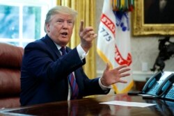 President Donald Trump speaks in the Oval Office of the White House in Washington, Friday, July 26, 2019. Trump announced that Guatemala is signing an agreement to restrict asylum applications to the U.S. from Central America.