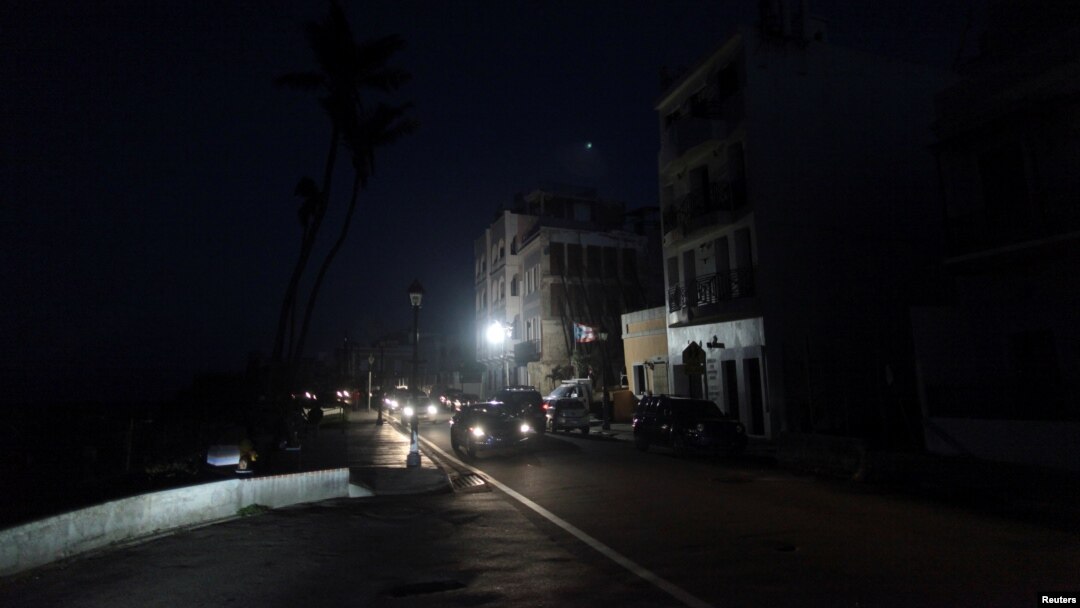 Cars drive on a street in the light of a generator-powered lamp set up by the municipality, after Hurricane Maria hit the island and damaged the power grid in September, in Old San Juan, Puerto Rico Oct. 26, 2017.