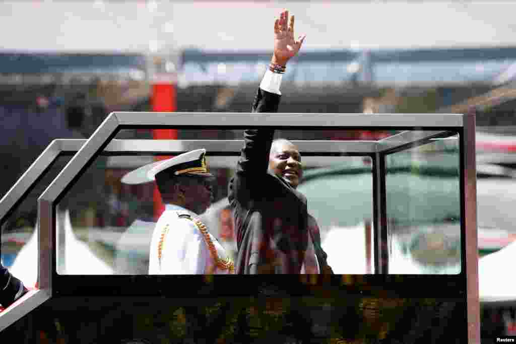 Kenya&#39;s President Uhuru Kenyatta waves upon his arrival to his inauguration ceremony where he will be sworn in as president at Kasarani Stadium in Nairobi.