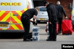 FILE - Inspectors from the Organization for the Prohibition of Chemical Weapons (OPCW) arrive to begin work at the scene of a nerve agent attack on former Russian agent Sergei Skripal, Salisbury, Britain, March 21, 2018.