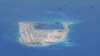 FILE PHOTO - Chinese dredging vessels are purportedly seen in the waters around Fiery Cross Reef in the disputed Spratly Islands in the South China Sea in this still image taken by a P-8A Poseidon surveillance aircraft, May 21, 2015. 