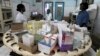 Nurses work in the pharmacy at the general hospital in Man, western Ivory Coast, July 4, 2013. 