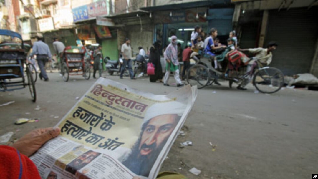 A man reads a local newspaper reporting the death of al-Qaida leader Osama bin Laden in the old quarters of Delhi, May 3, 2011