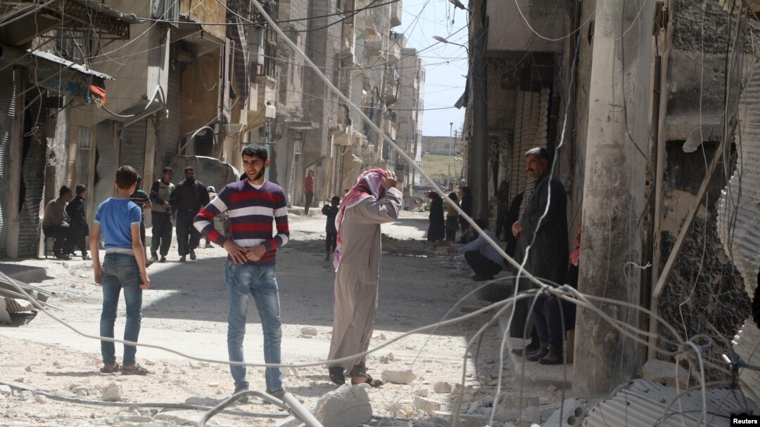 FILE - Residents inspect damages after an airstrike on the rebel held al-Maysar neighborhood in Aleppo, Syria, April 11, 2016. 