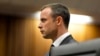 Olympic and Paralympic track star Oscar Pistorius stands in the dock during his trial at the North Gauteng High Court in Pretoria, South Africa, March 3, 2014.