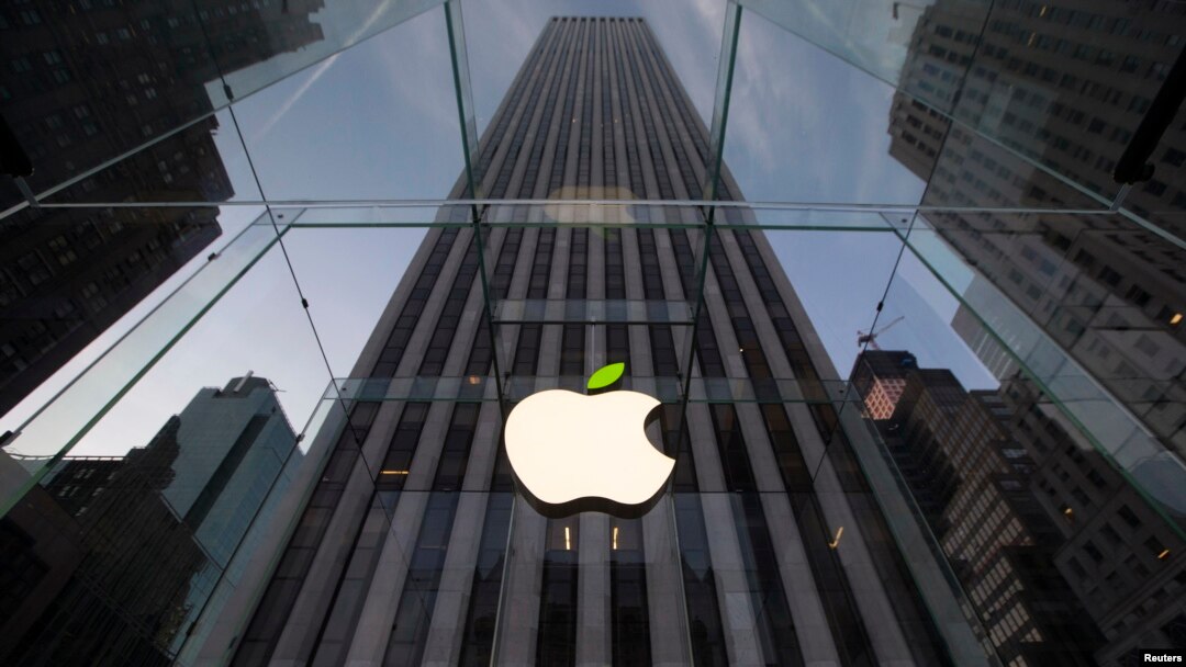 FILE - The leaf on the Apple symbol is tinted green at the Apple flagship store on 5th Ave in New York, April 22, 2014.