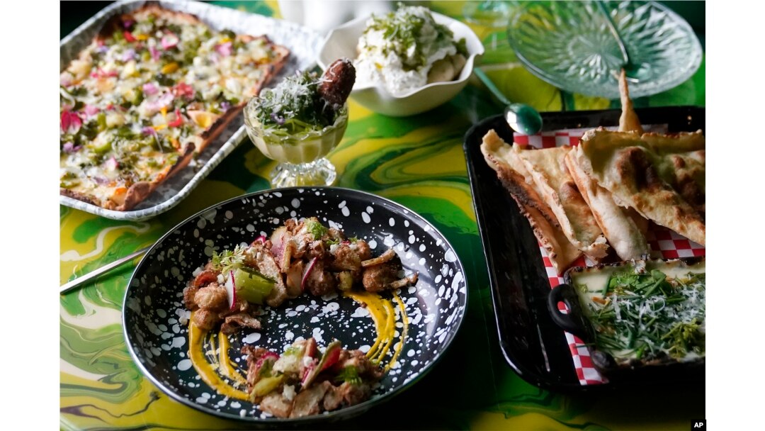 Multiple dishes are shown at a table at Shuggie's Trash Pie restaurant in San Francisco on June 14, 2023. (AP Photo/Jeff Chiu)
