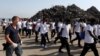 Migrants are escorted by Italian police after disembarking from Vos Hestia ship of NGO "Save the Children" in the Sicilian harbour of Augusta, Italy, Aug. 4, 2017.