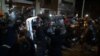 In a second night of violence following a grand jury&#39;s decision not to indict a white police officer in the shooting death of a black teenager, protesters attack and turn over a police car outside Ferguson City Hall, in Ferguson, Missouri, Nov. 25, 2014.