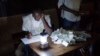 A Malian poll worker counts ballots in Bamako Aug. 11, 2013.