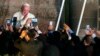 Faithful take photos with their mobile phones as Pope Francis departs from San Francisco Church aboard the Popemobile, in Quito, Ecuador, July 7, 2015. 