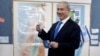 Israeli Prime Minister Benjamin Netanyahu casts his ballot at a polling station in Jerusalem, January 22, 2013.