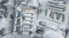 This handout satellite image released by Maxar Technologies shows armored personnel carriers and trucks at Klimovo storage facility, in Russia's Bryansk region, some 13 kilometers north of its border with Ukraine, Jan. 19, 2022.